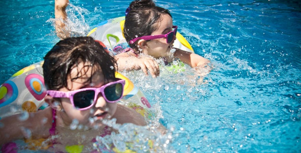 Kids swimming indoors at waterpark in Minnesota.