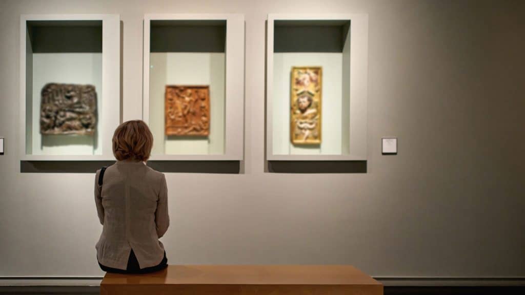 Woman looking at works of art