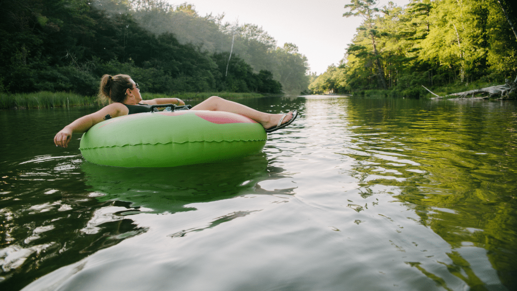 Woman on an innertube floating on a MN river